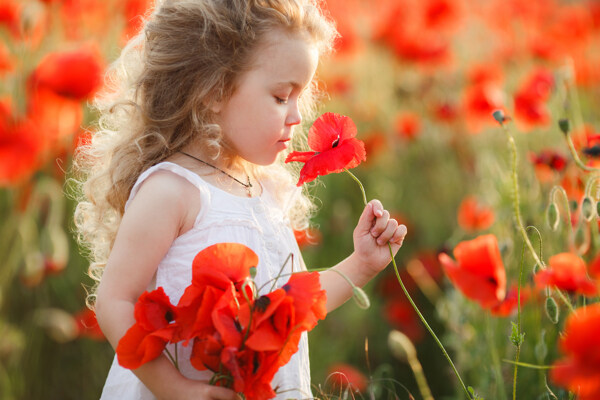 闻红色花朵的小女孩图片